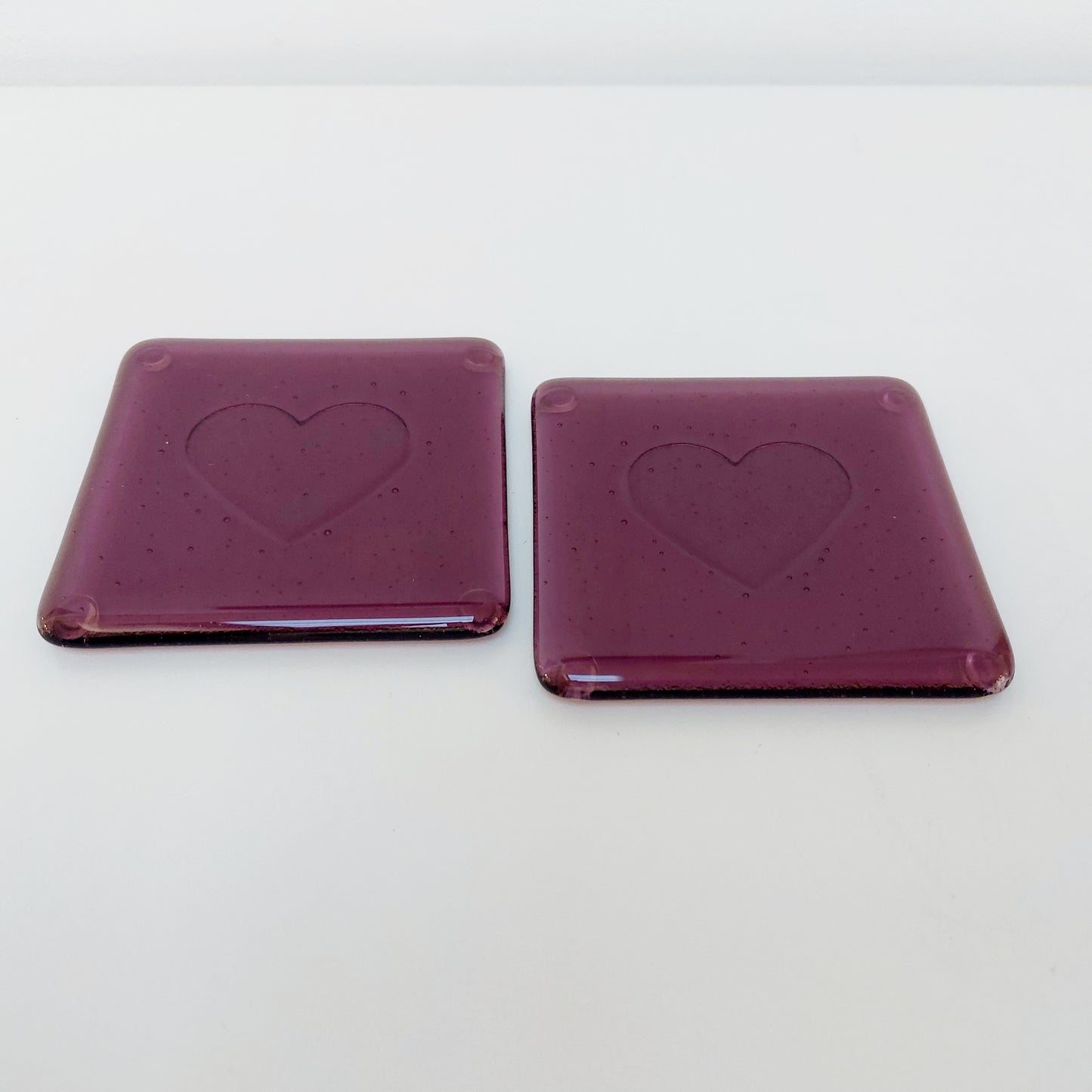 Plum Glass Coasters with a Kiln Carved Heart Design